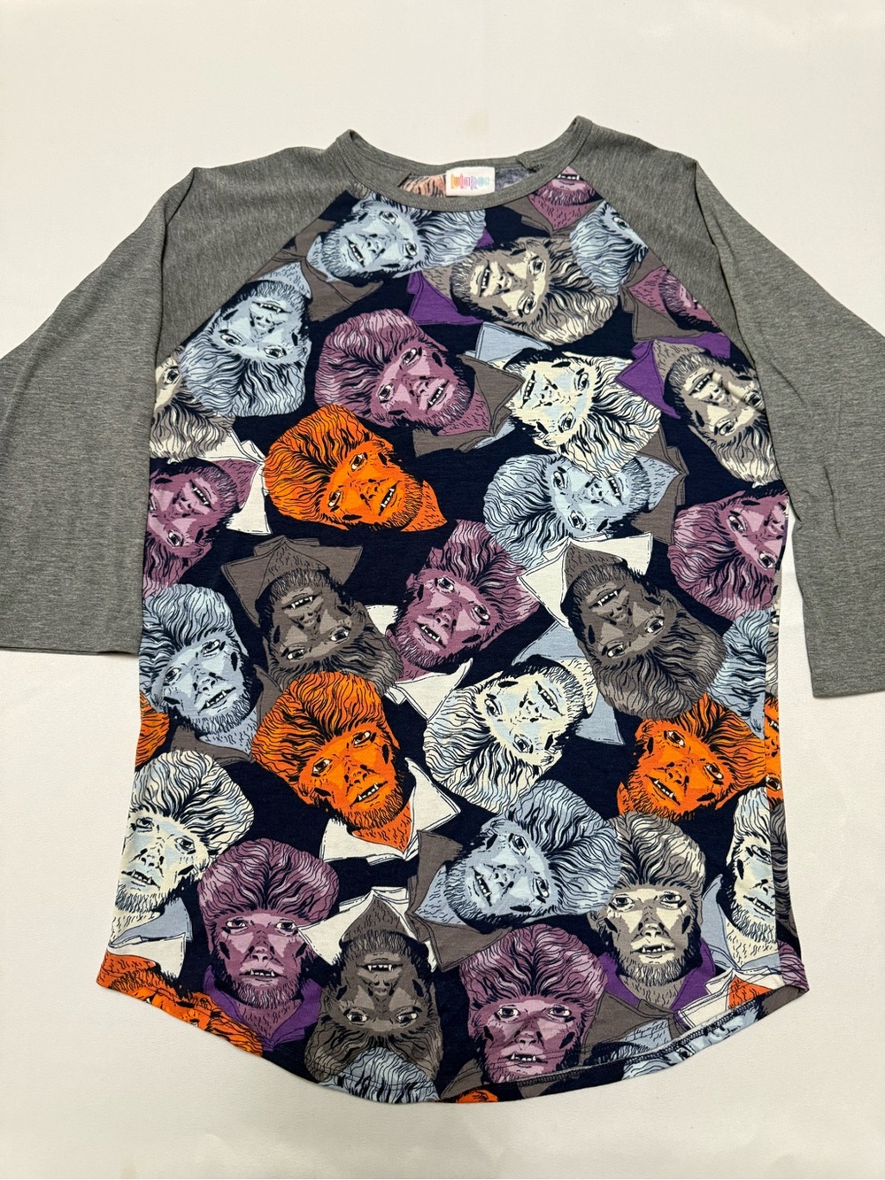 LuLaRoe Women’sRaglan Top with Orange, Purple, Gray, Blue & Cream Werewolf Faces